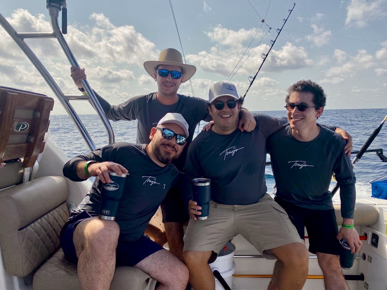 Group of friends in Torrojo shirts on the boat