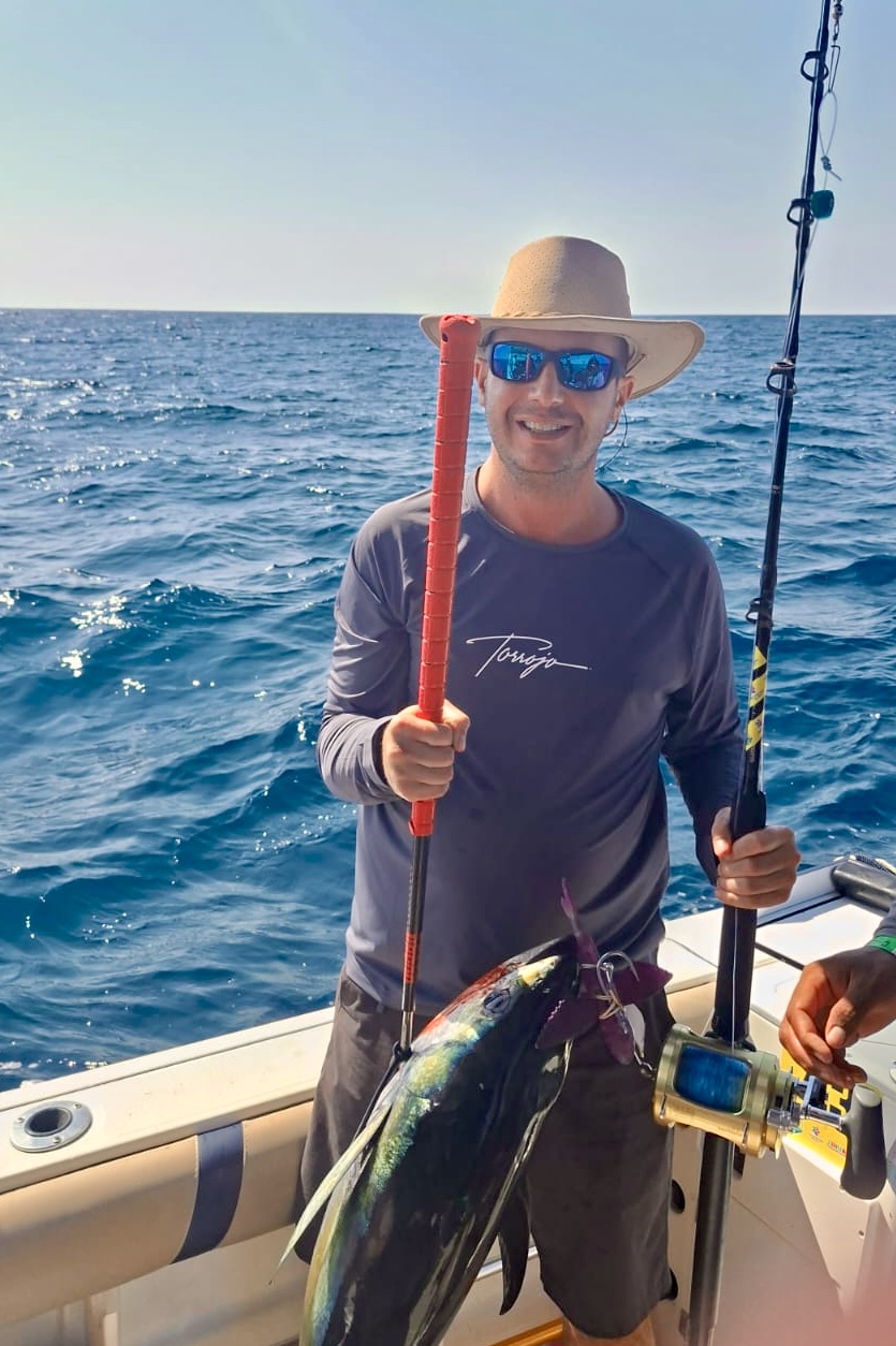 Angler in a Torrojo shirt with a yellowfin tuna