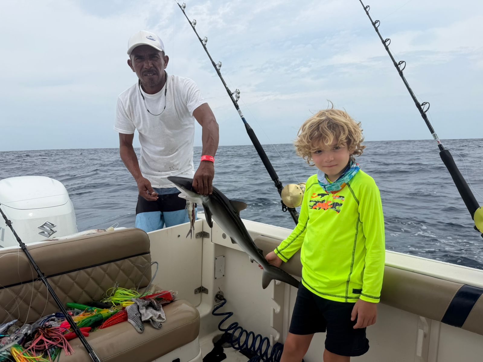 Kid holding a shark caught aboard Torrojo