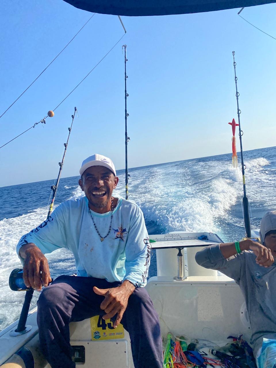 Captain Mario smiling at the transom while trolling